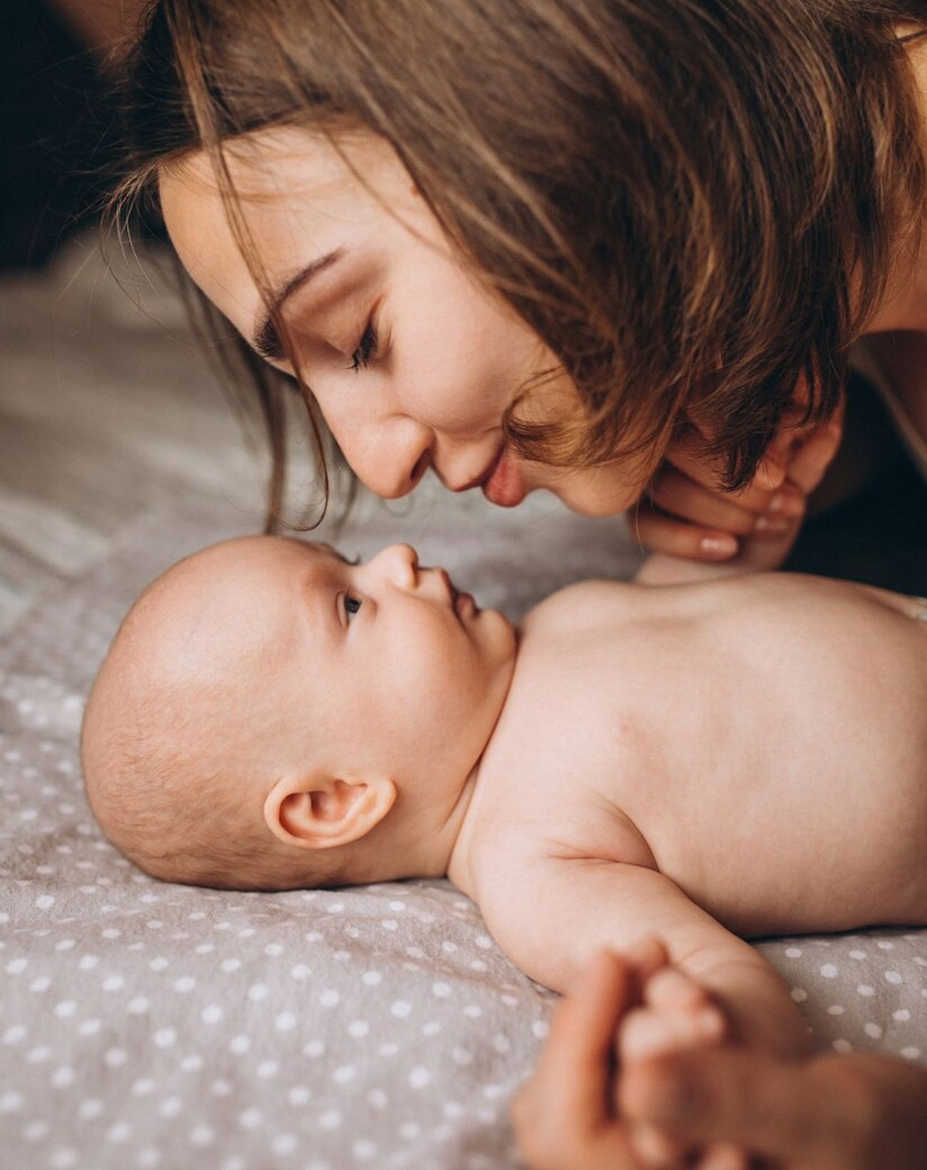 a mother cooing over her baby