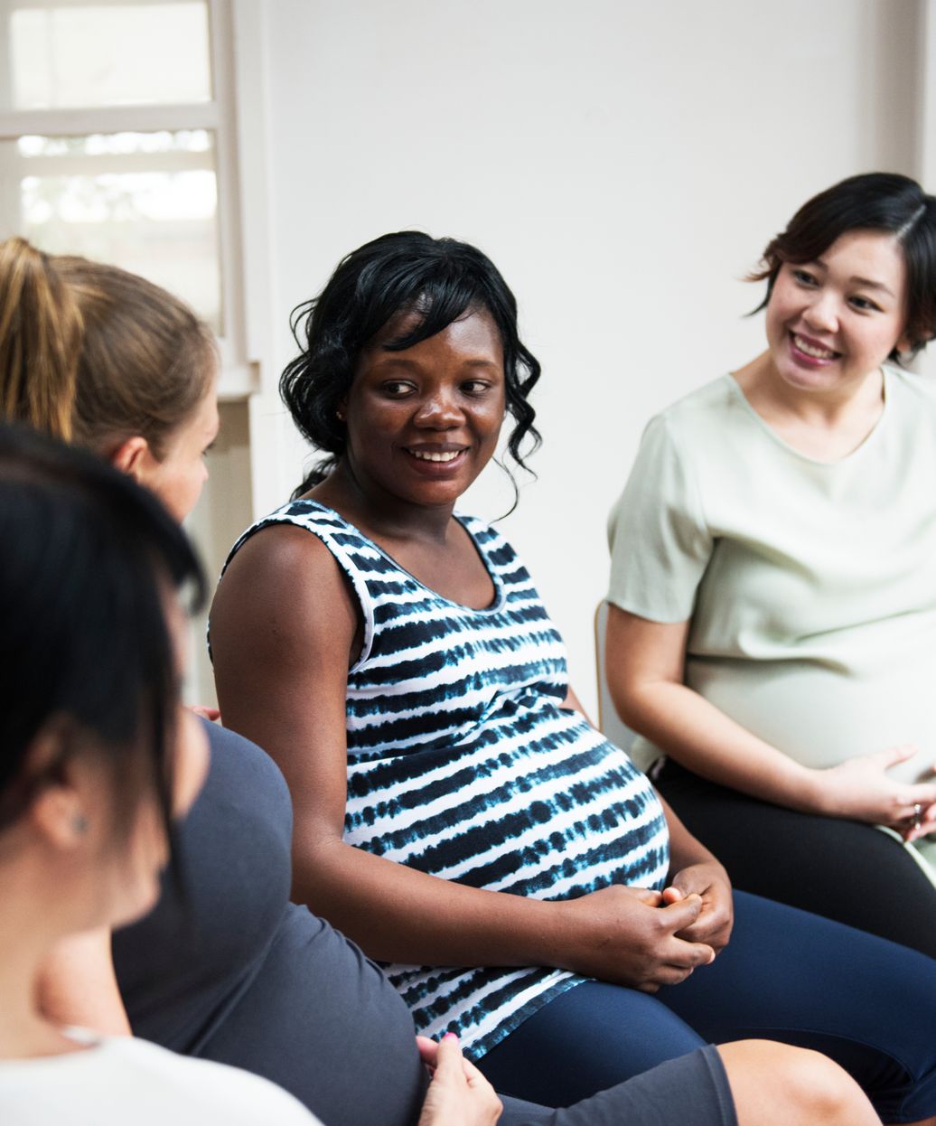 a group of pregnant ladies sitting in a circle