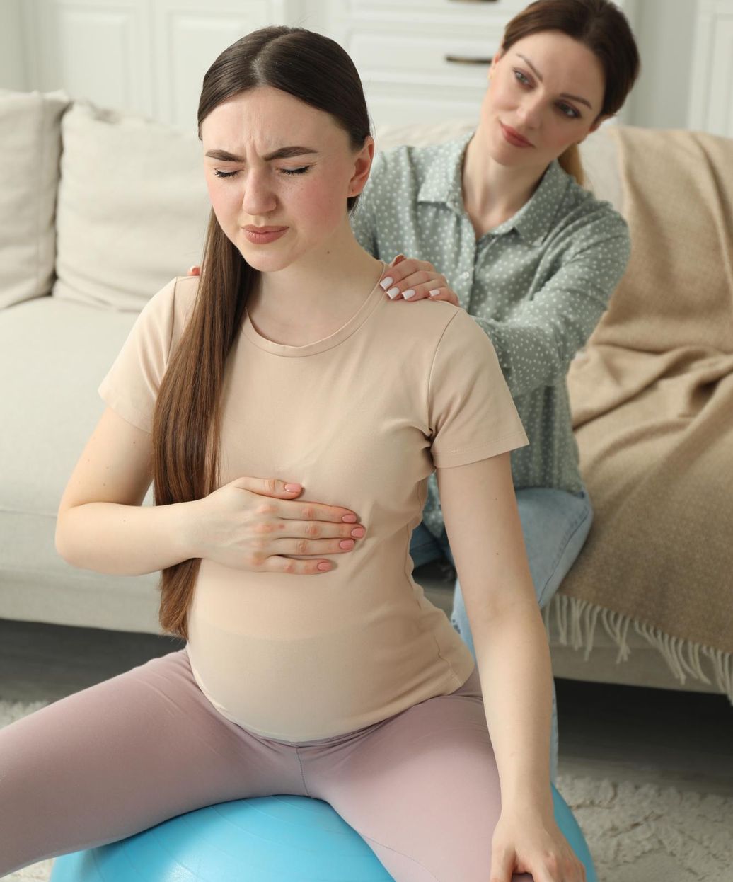 a woman giving birth on a yoga ball